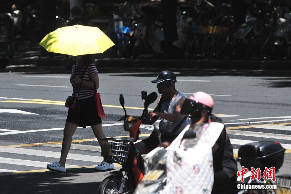 福州持續(xù)高溫 市民“全副捂裝”出行